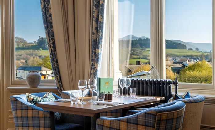 Table in a restaurant with a view of the countryside from the window